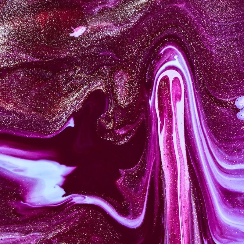 A person in a flowing yoga pose, viewed from above, creating a dynamic shape.