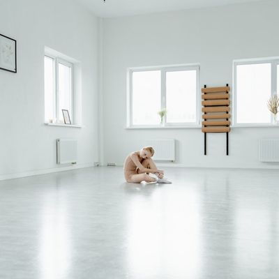 An empty, serene yoga studio with natural light coming through a window.