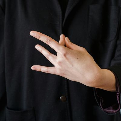 Close-up of hands in a specific mudra position during meditation.